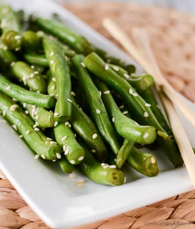 fresh cooked easy green beans on a plate with chopsticks