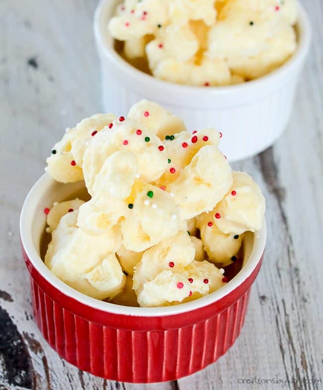 puffcorn with white almond bark and sprinkles in red and white bowls