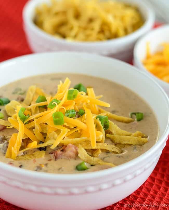 bowl of nacho soup with cheese and green onions