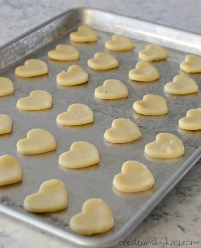 shortbread hearts on a cookie sheet before baking