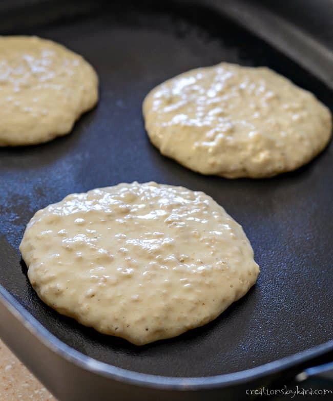 oatmeal pancakes cooking on a skillet