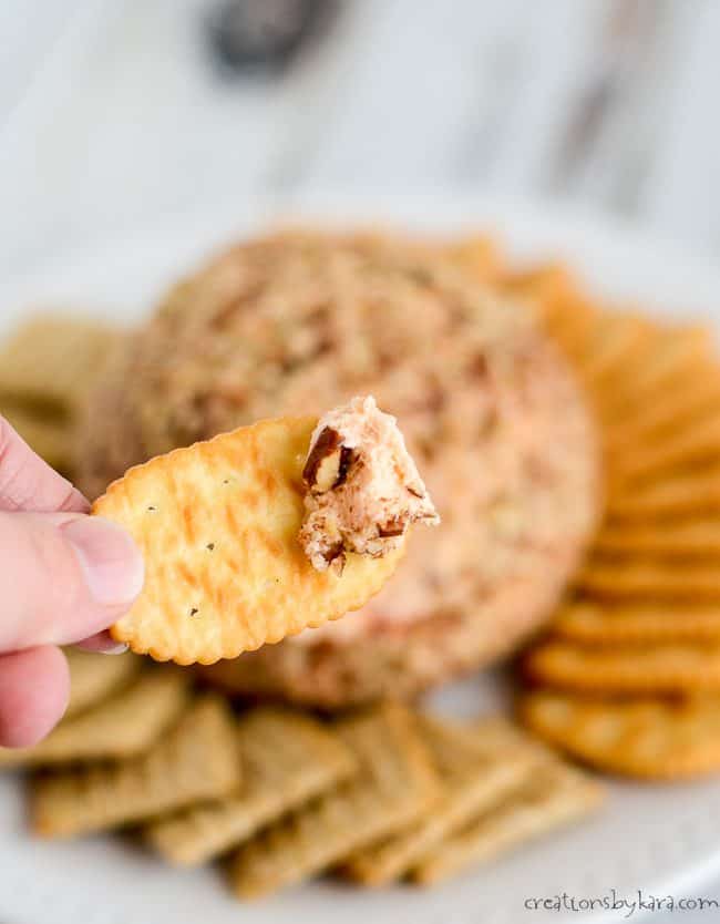 cheese ball with pimentos on a cracker