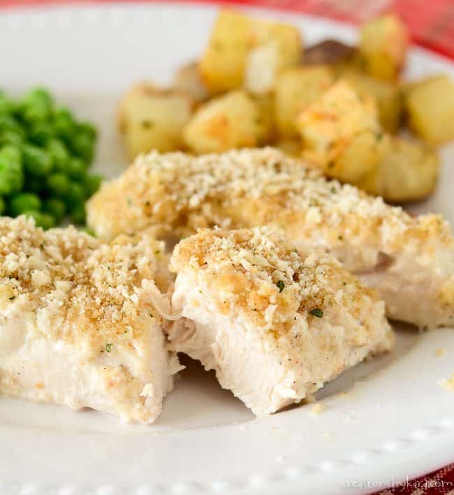 mayonnaise chicken cut on a plate with potatoes and peas