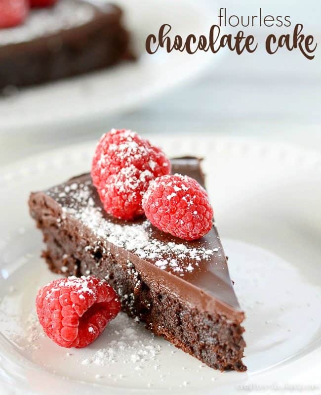 slice of flourless chocolate cake topped with raspberries