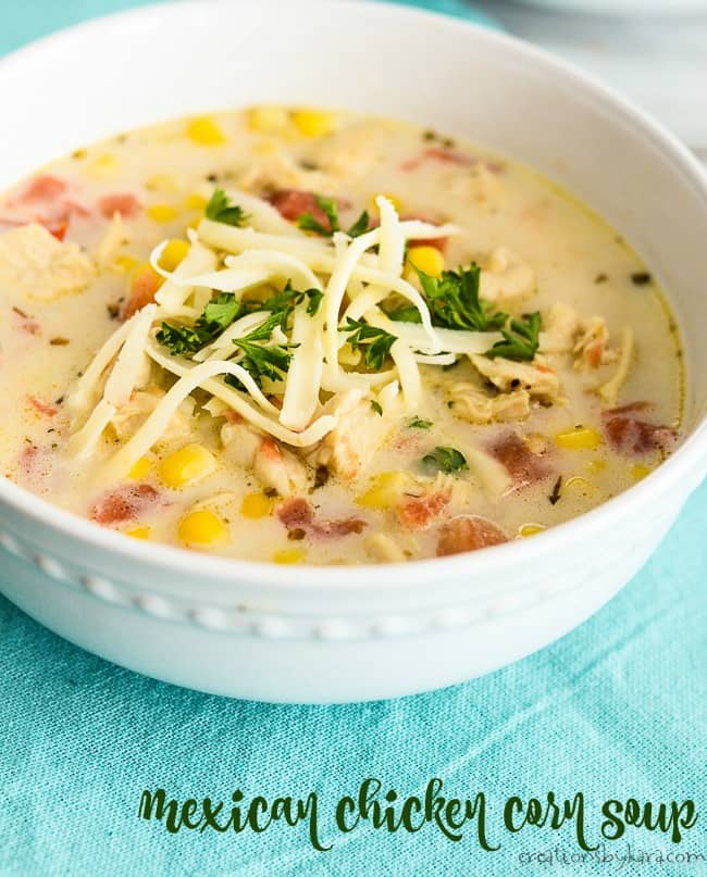 bowl of mexican chicken corn soup with cheese and parsley