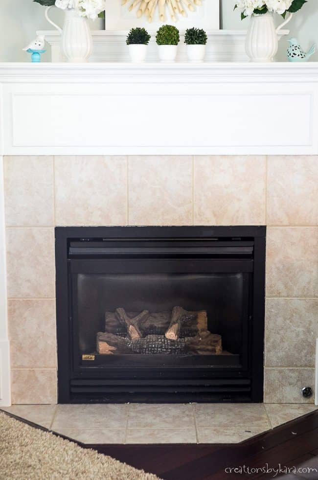 reveal of brass fireplace makeover with black paint