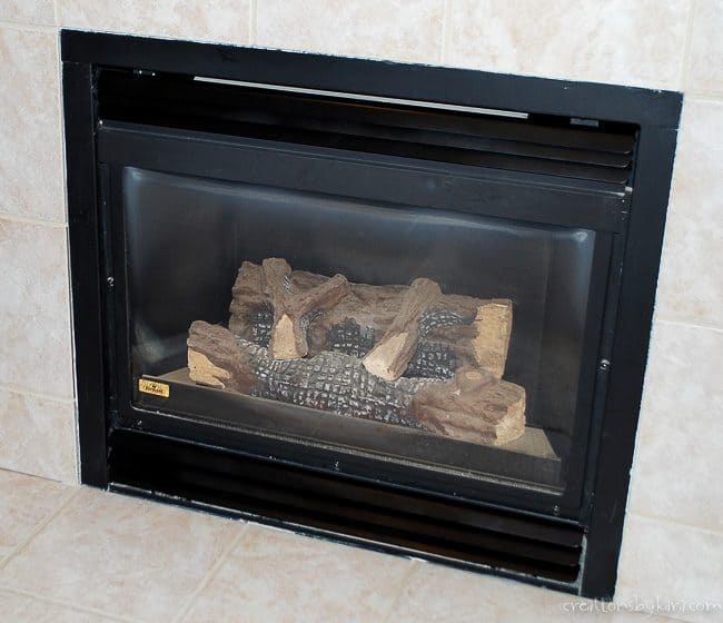 brass fireplace updated with black spray paint
