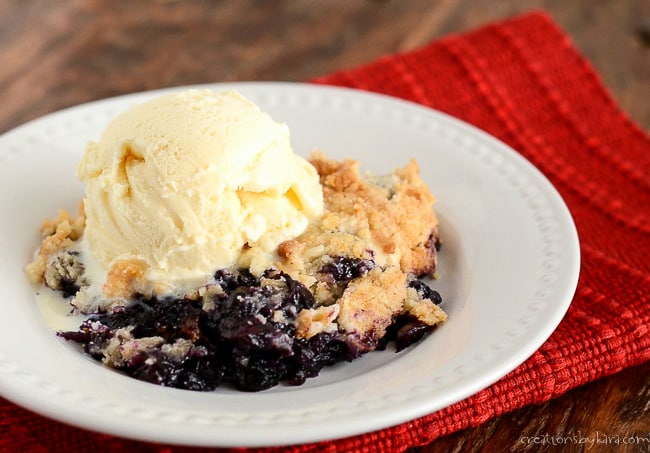 blueberry dump cake with a scoop of vanilla ice cream