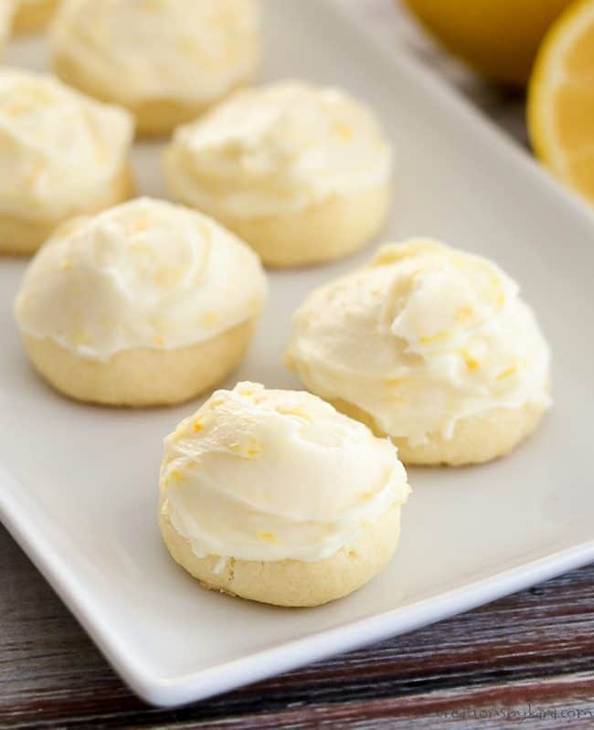 Butter cookies with lemon cream cheese frosting on a white tray