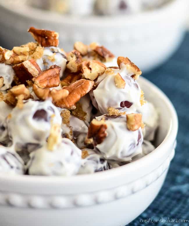 close up of pecans and brown sugar on top of creamy grape salad
