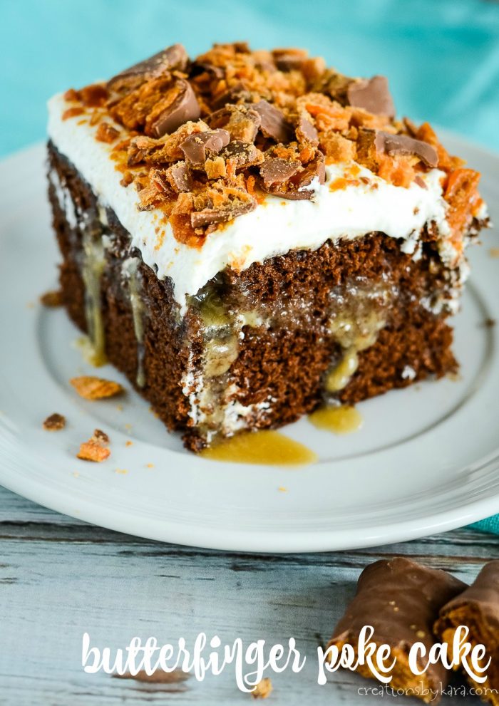 piece of chocolate Butterfinger poke cake on a white plate
