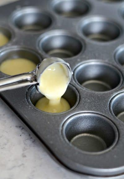 using cookie scoop for scooping batter into mini muffin pans
