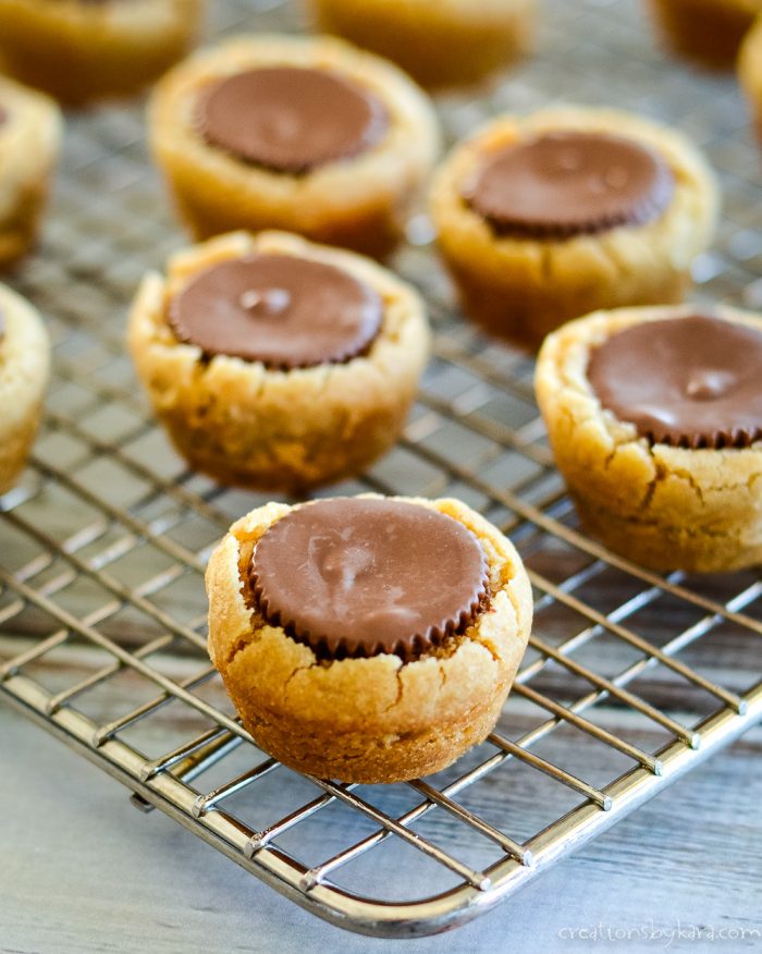 peanut butter cookies with peanut butter cups on a cooling rack