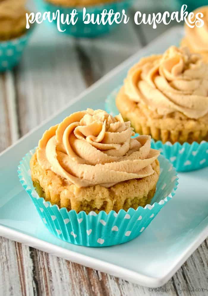 peanut butter cupcakes with peanut butter frosting on a white tray