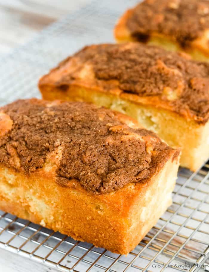 loaves of apple quick bread cooling on wire racks