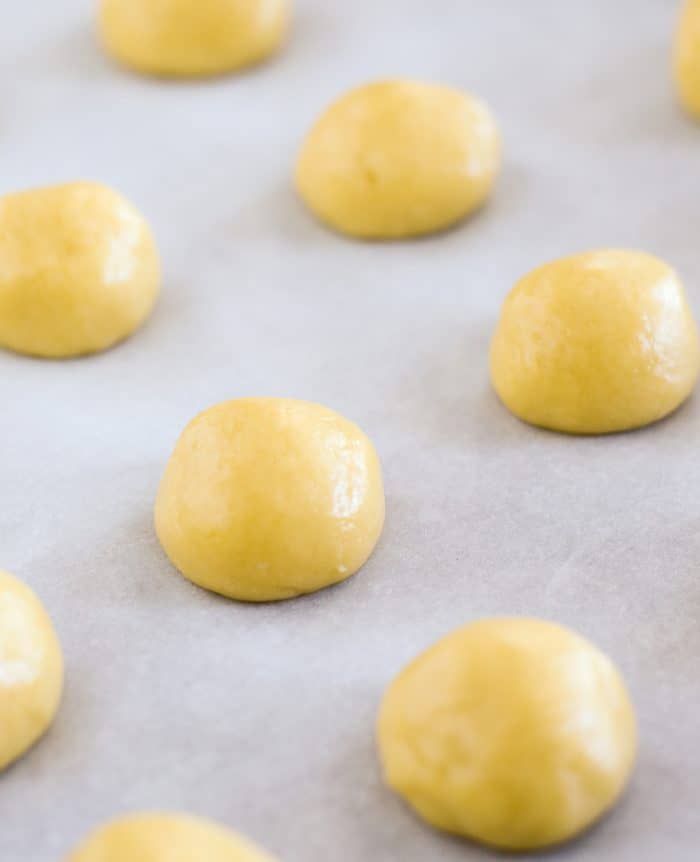 balls of cookie dough on parchment paper