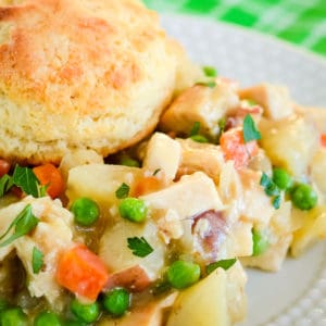 close up of chicken pot pie topped with a biscuit