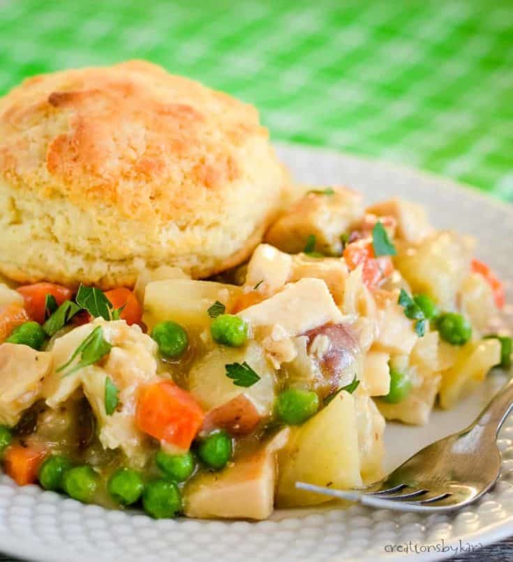 plate of crock pot chicken pot pie topped with a biscuit