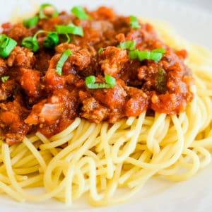 meaty marinara sauce over hot pasta topped with fresh basil