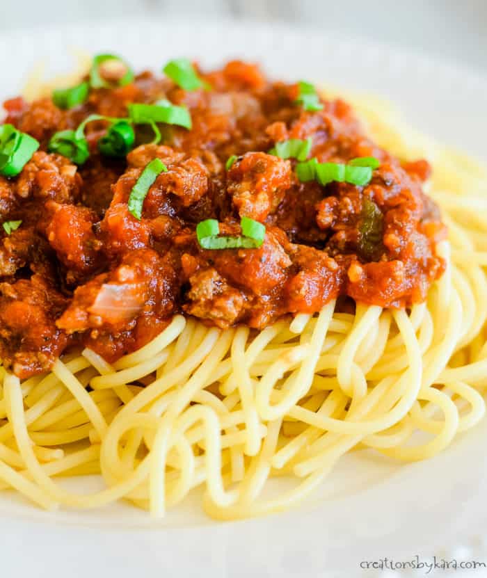 meaty marinara sauce over hot pasta topped with fresh basil