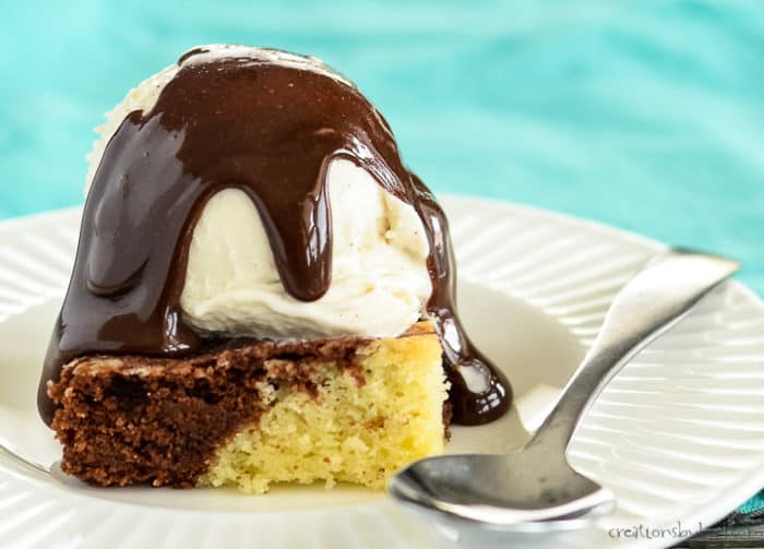 swirled brownie on a white plate with vanilla ice cream and hot fudge