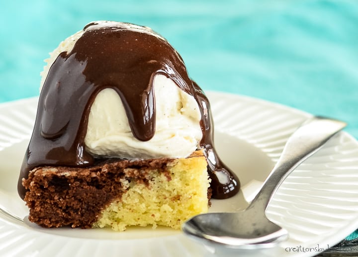 swirled brownie on a white plate with vanilla ice cream and hot fudge