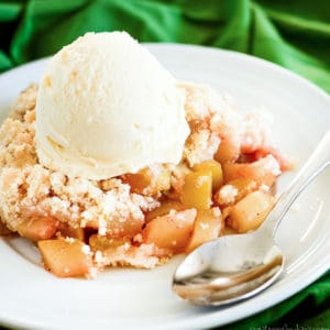 plate of mock apple crisp made with zucchini, topped with vanilla ice cream