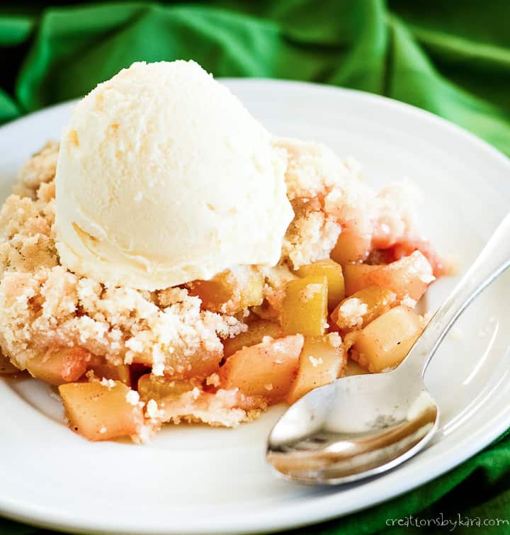 plate of mock apple crisp made with zucchini, topped with vanilla ice cream