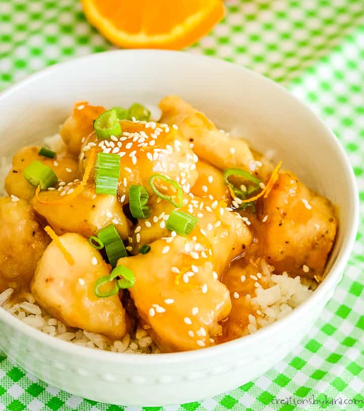 baked orange chicken sprinkled with green onions and sesame seeds