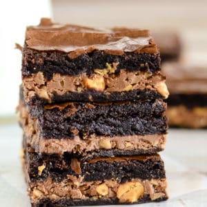 stack of candy bar brownies on waxed paper