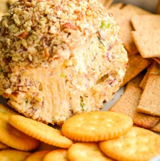 close up of inside of a bacon cheese ball surrounded with crackers