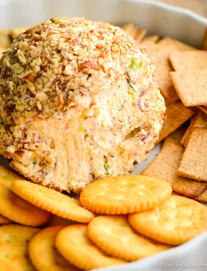 close up of inside of a bacon cheese ball surrounded with crackers