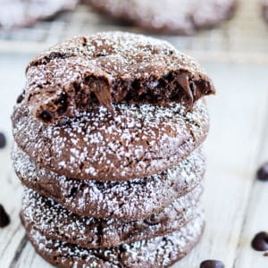 chocolate cookies with chocolate chips sprinkled with powdered sugar