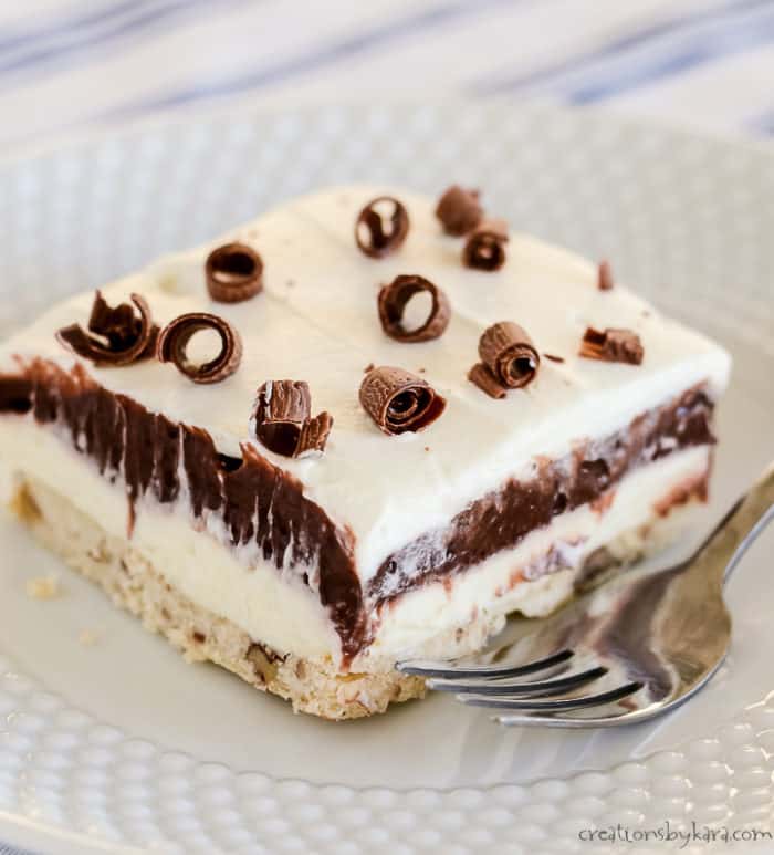 close up of chocolate layered dessert on a plate with a fork
