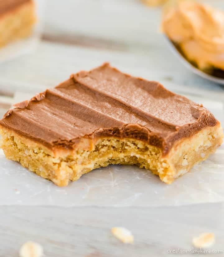 peanut butter oatmeal bar with chocolate frosting on a piece of waxed paper