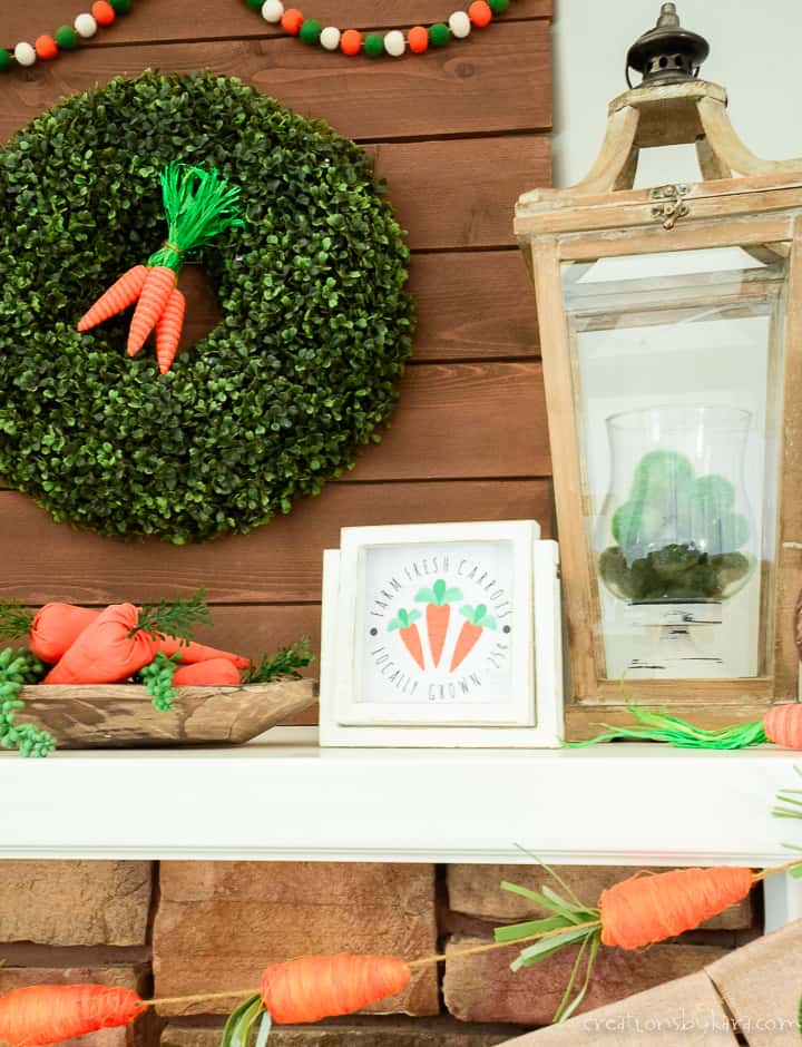 carrot sign and lantern on a mantel