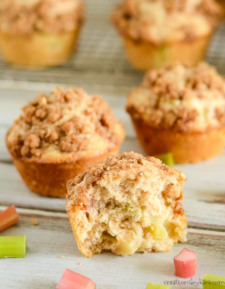 close up shot of halved rhubarb muffin with rhubarb chunks and cinnamon crumb topping