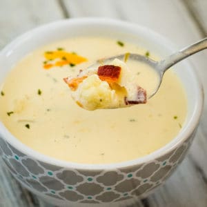 spoonful of cream of cauliflower soup with bacon and cheese