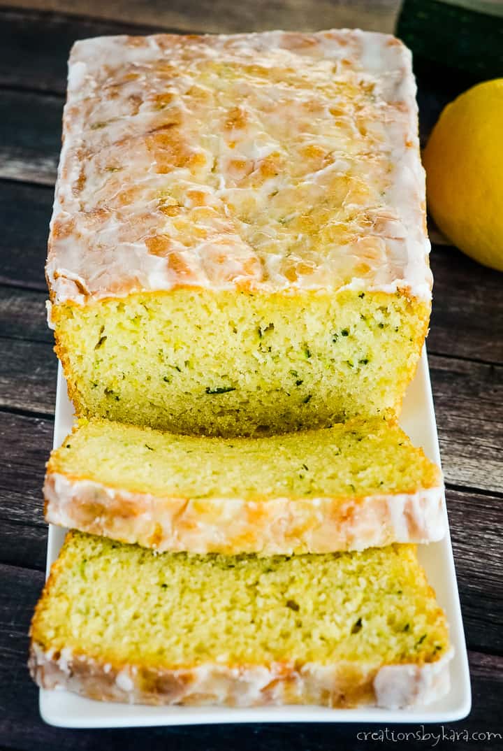 sliced loaf of lemon zucchini bread on a white tray