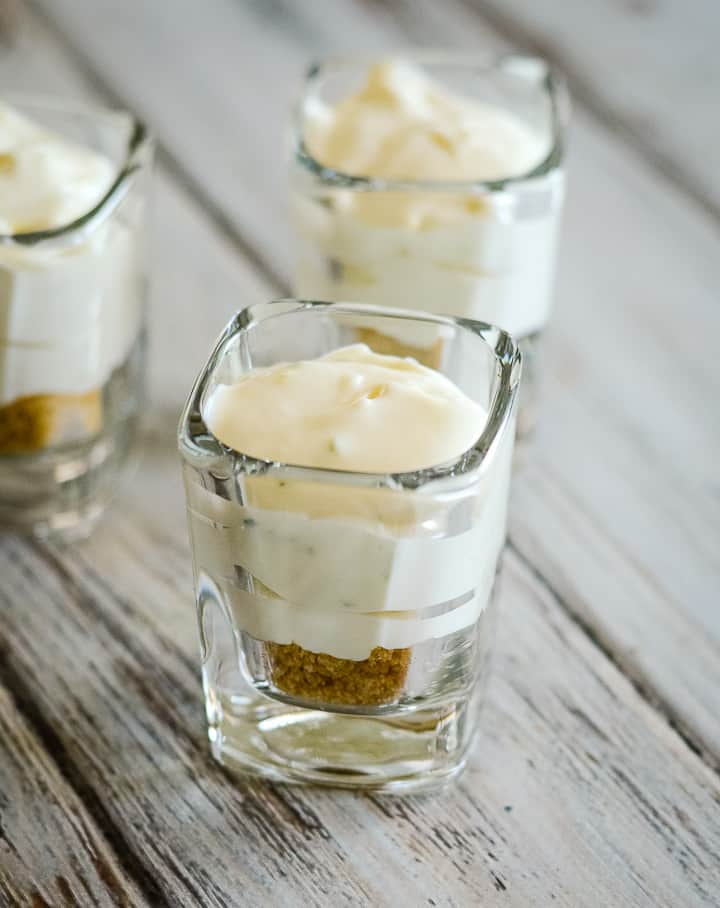 key lime mousse on top of crust in mini cups