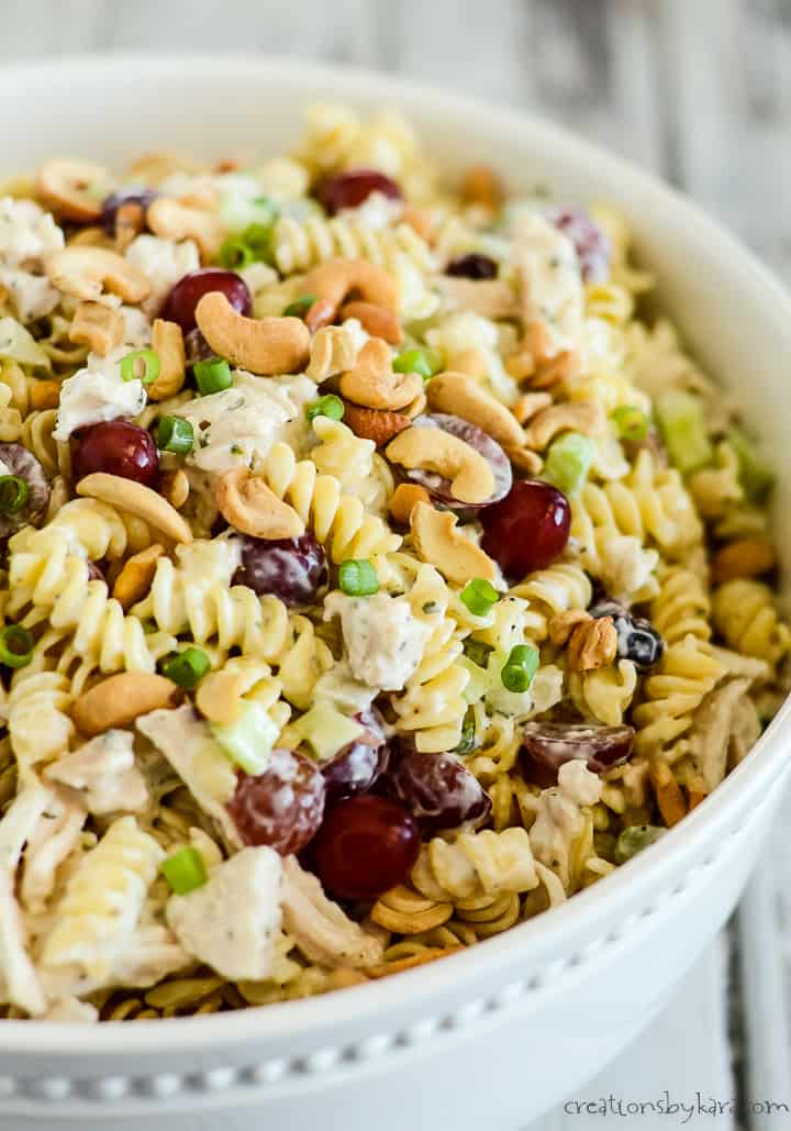 bowl of cold chicken pasta salad with grapes and cashews