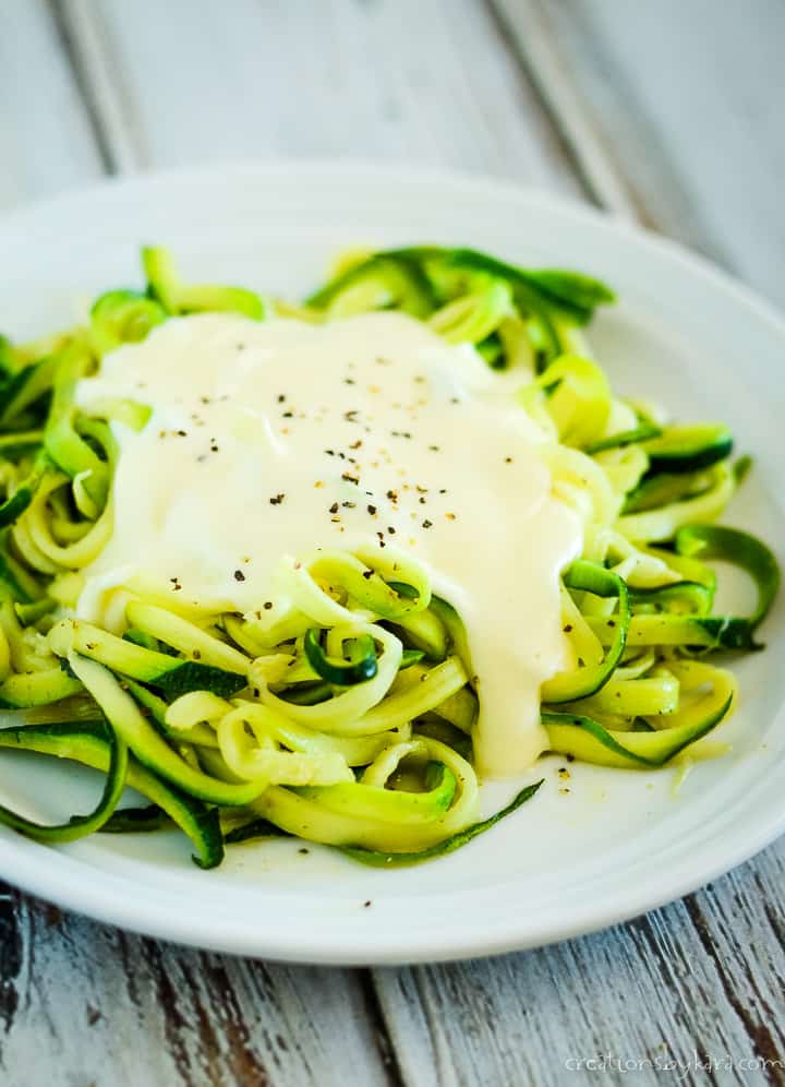 plate of keto alfredo sauce over zoodles