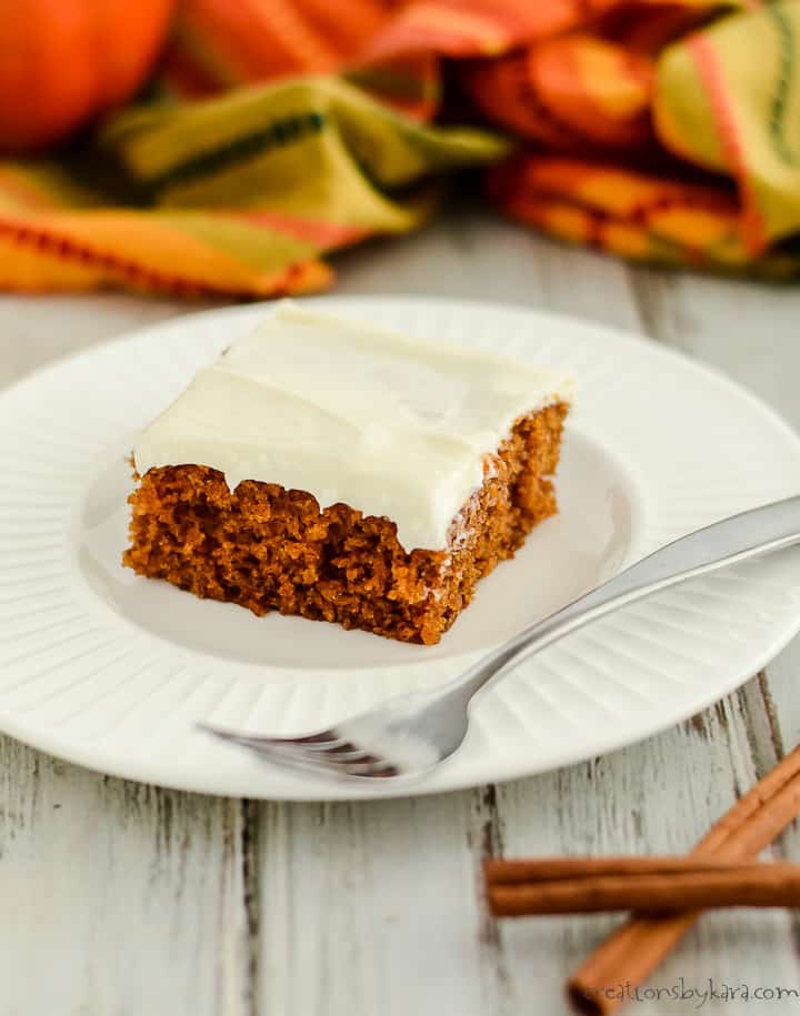 pumpkin bar with cream cheese frosting on a plate with a fork