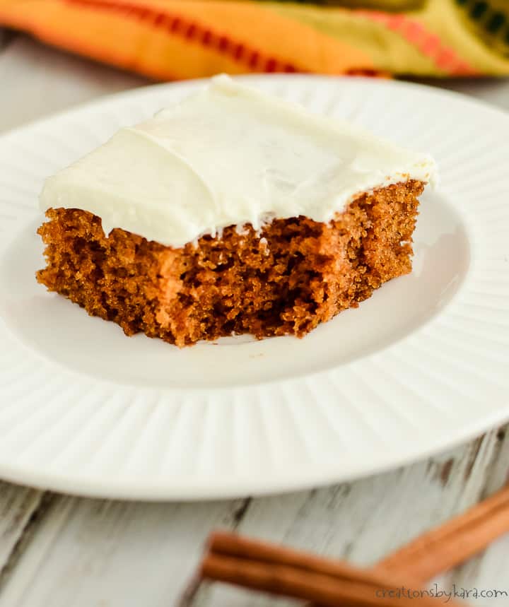 pumpkin bar with cream cheese frosting on a plate with a bite taken out