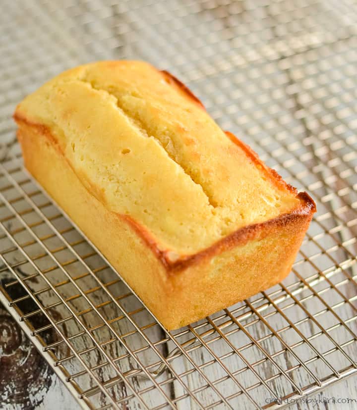 loaf of keto lemon pound cake cooling on a wire rack