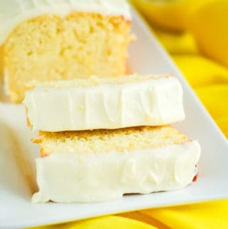 loaf of keto lemon pound cake sliced on a white serving tray