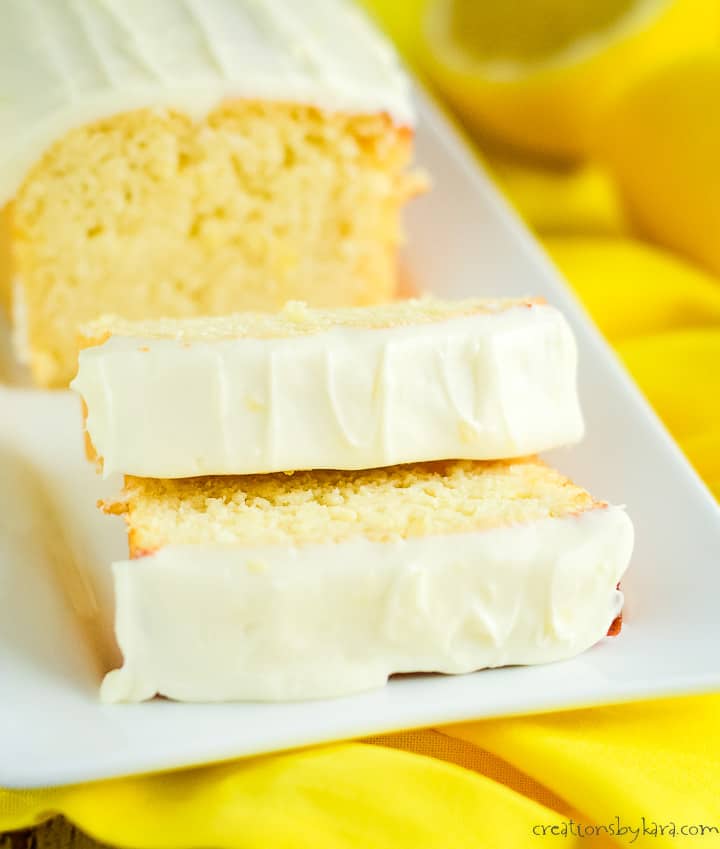 loaf of keto lemon pound cake sliced on a white serving tray