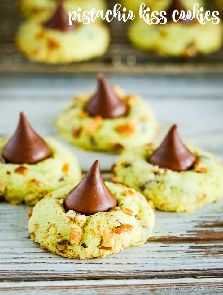 These Pistachio Kiss Cookies are just perfect for Christmas! A fun green Christmas cookie topped with a Hershey kiss. #christmascookies #kisscookies #puddingcookies #pistachiocookies -creationsbykara.com pistachio kiss cookies