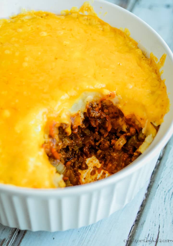 casserole dish with shepherd's pie with a serving taken out