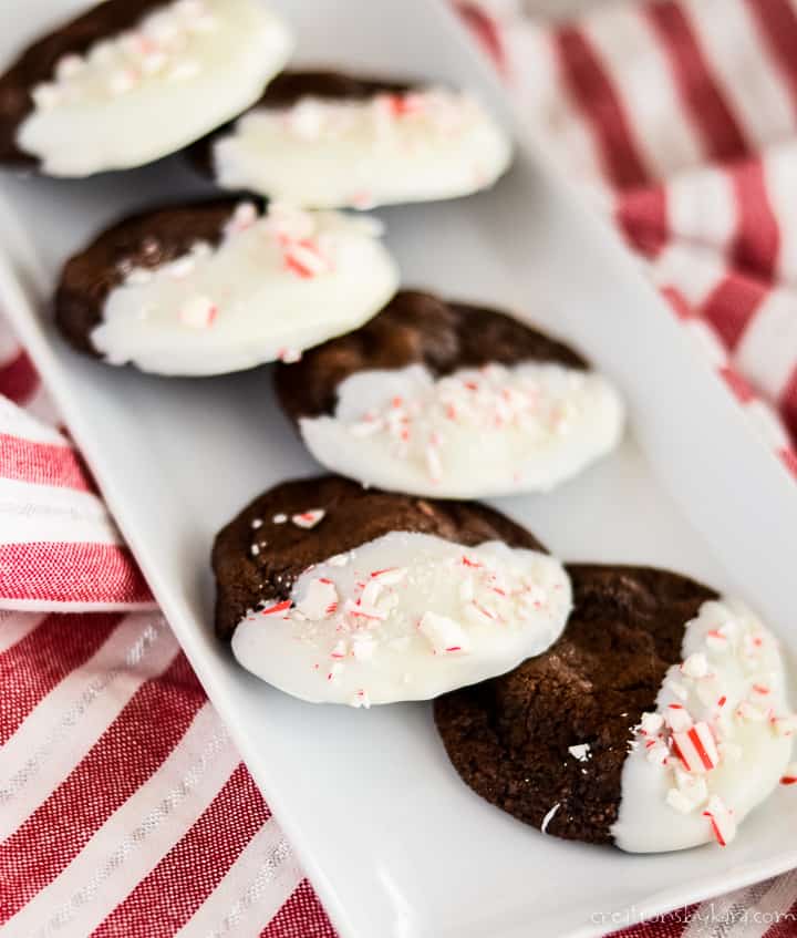 tray of peppermint chocolate chip cookies dipped in white chocolate and sprinkled with candy cane bits